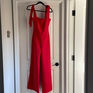 True Violet wide leg jumpsuit with adjustable tie straps in bright red